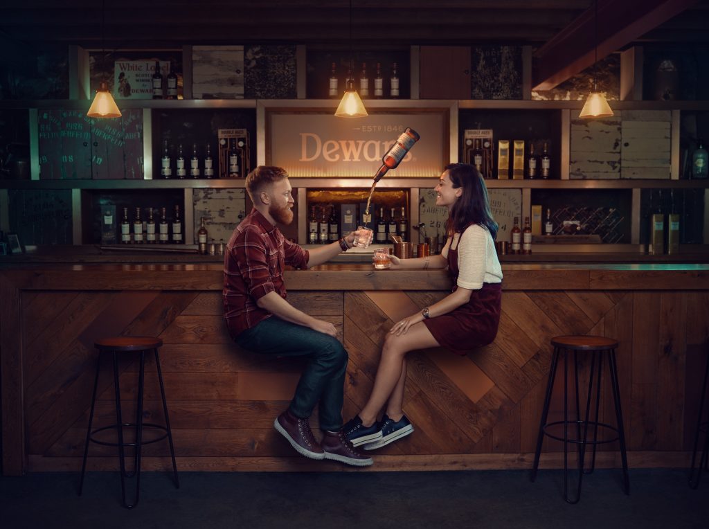 man and woman drinking at whiskey distillery photo by Todd Antony